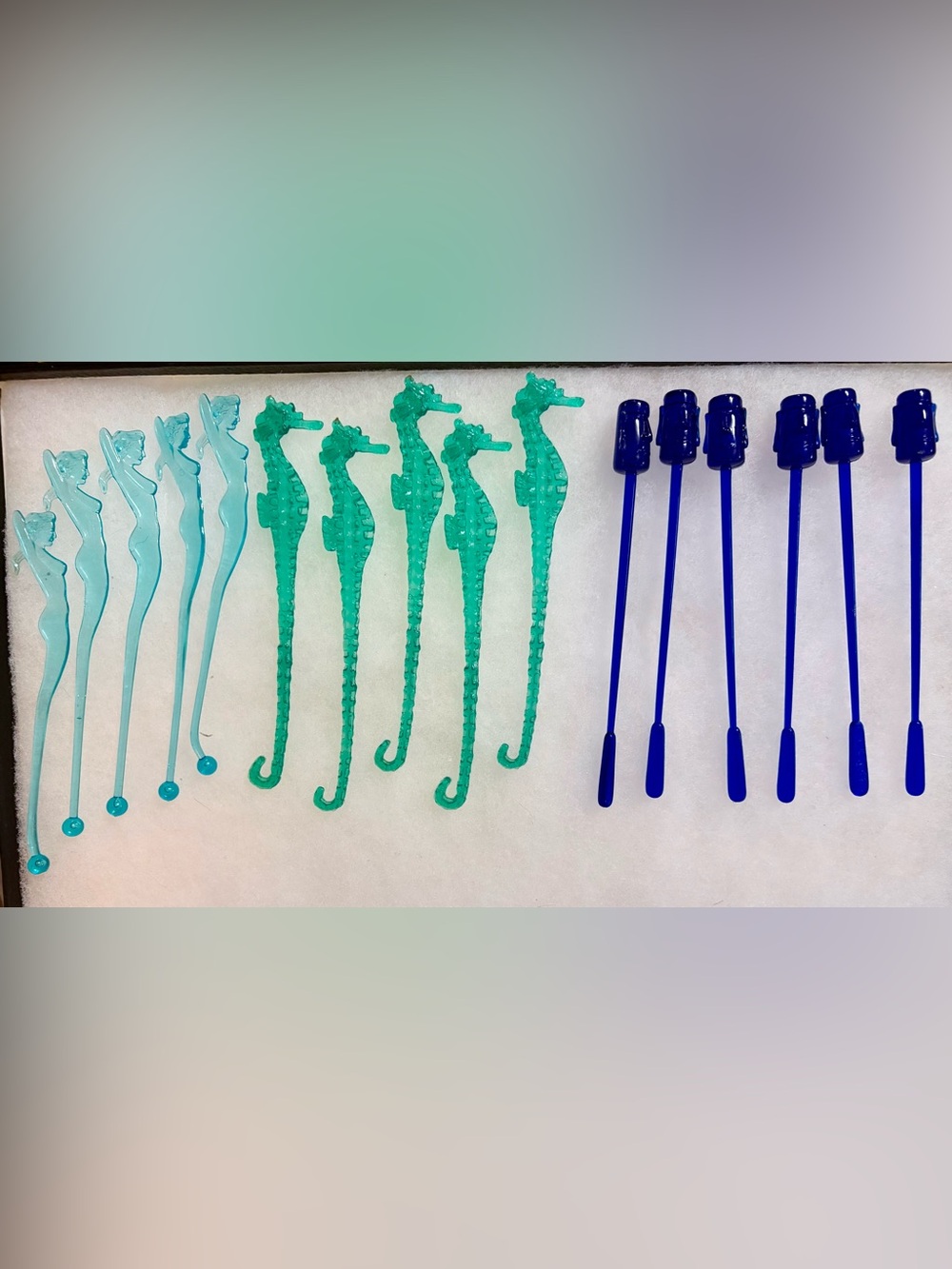 16 plastic drink swizzle sticks including pinup girls, seahorses, tiki statues